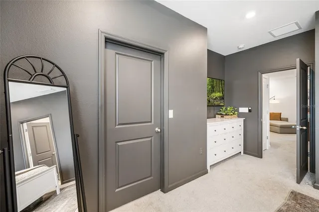 a view of a cabinet and mirror in a bedroom