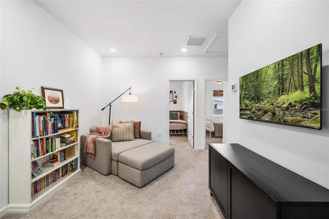 a living room with furniture and a book shelf