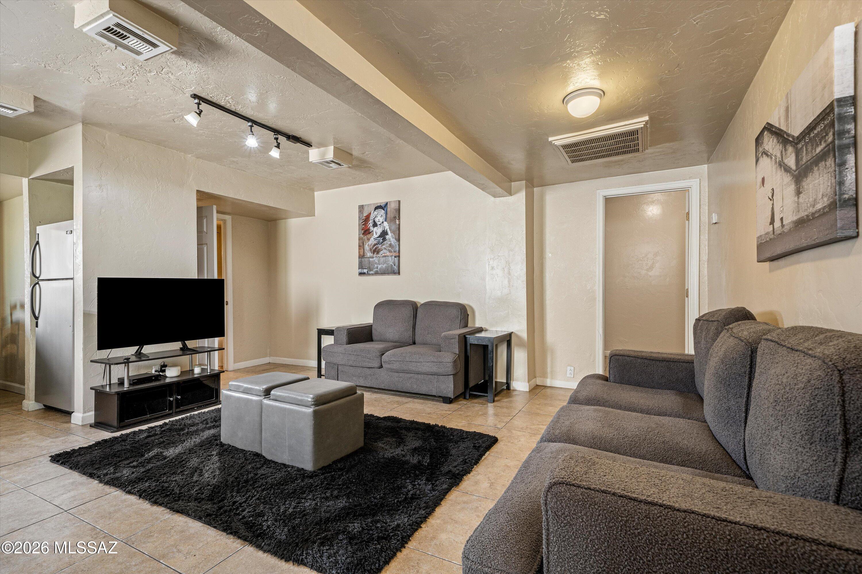 2619 East Prince Road Tucson, AZ 85716 - Photo 43 of 50 a living room with furniture and a flat screen tv