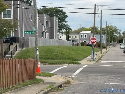 a view of a street with a cars park side of a road