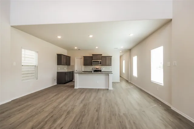 a view of kitchen with refrigerator sink and microwave