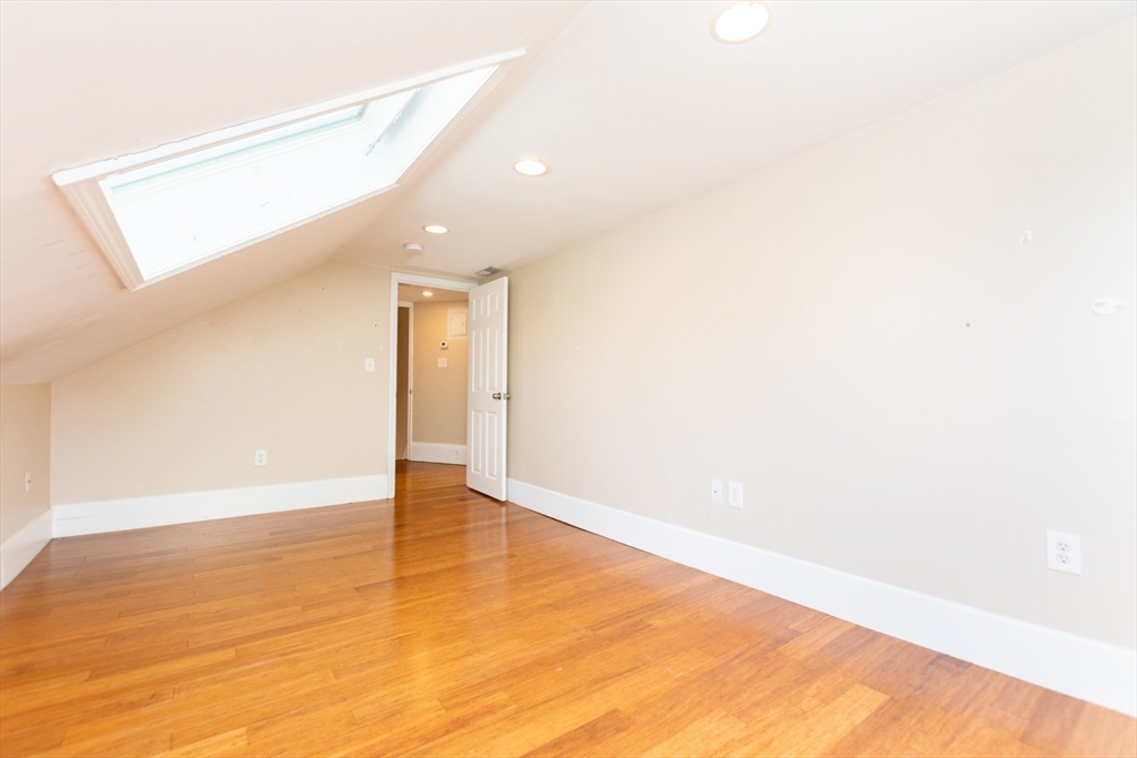 27 Shannon Street, Unit 2L Boston, MA 02135 - Photo 14 of 22 a view of an empty room with wooden floor