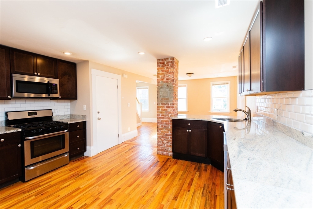 27 Shannon Street, Unit 2L Boston, MA 02135 - Photo 2 of 22 a living room with stainless steel appliances furniture and a flat screen tv