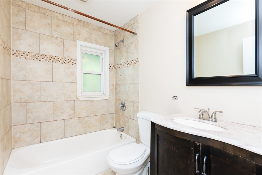 27 Shannon Street, Unit 2L Boston, MA 02135 - Photo 5 of 22 a bathroom with a sink a toilet a mirror and bathtub