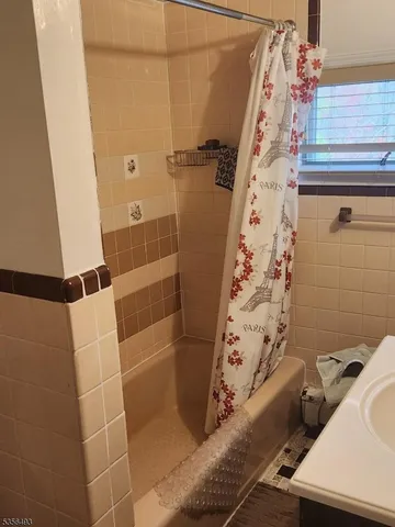 a bathroom with a bathtub and shower