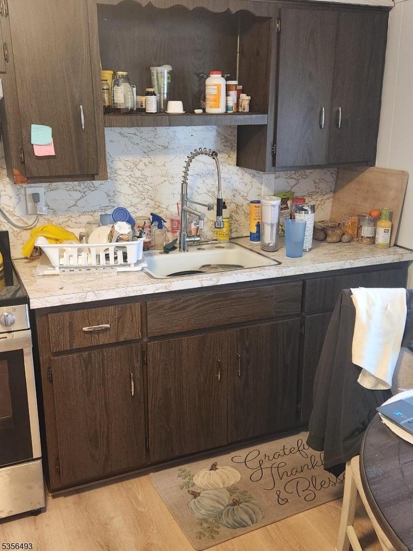 1424 East Front Street, Unit 2 Plainfield, NJ 07062 - Photo 6 of 6 a kitchen with a sink and a wooden cabinets