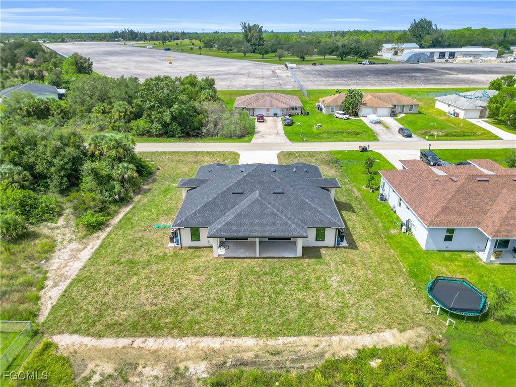 2508-2510 Park Road Lehigh Acres, FL 33971 - Photo 29 of 37 a aerial view of a house with pool and a yard