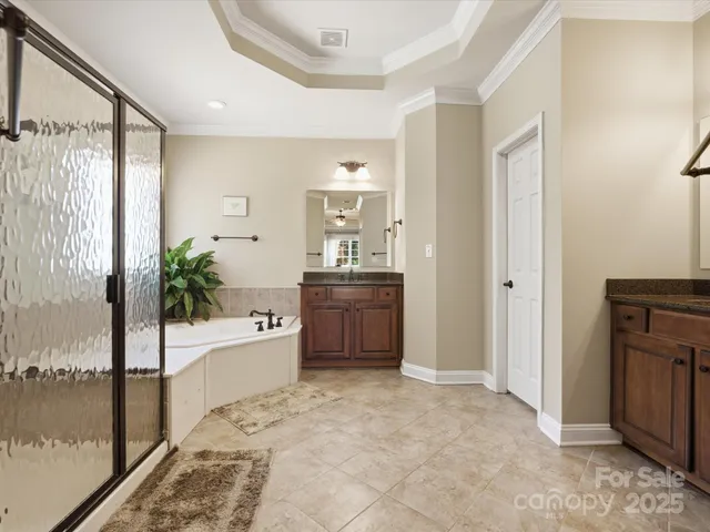 a bathroom with a bathtub shower and a mirror