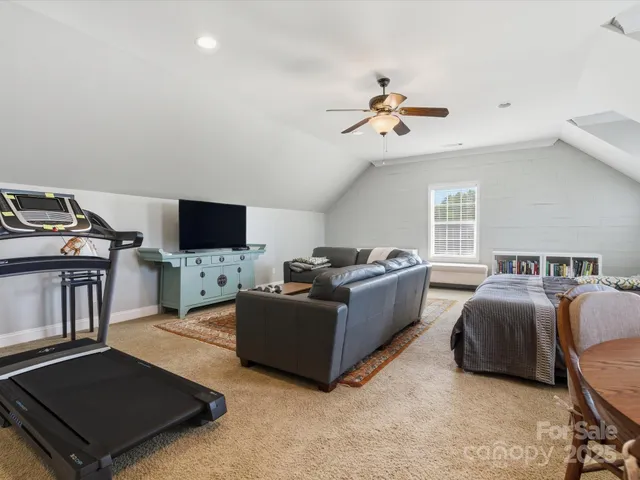 a bathroom with a granite countertop sink mirror vanity and toilet