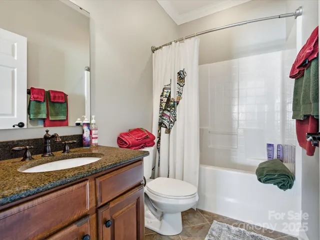 a view of a balcony with chairs and wooden fence