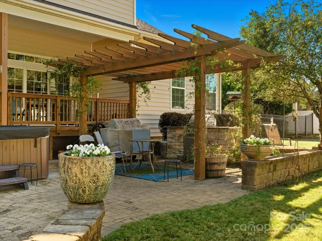 a view of a house with backyard sitting area and garden