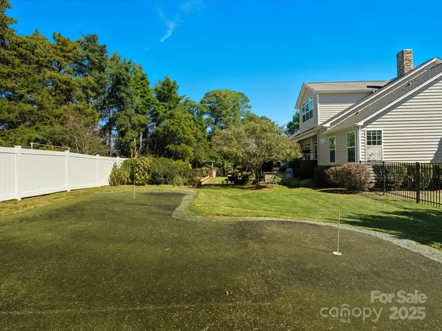 an aerial view of residential houses with outdoor space and parking