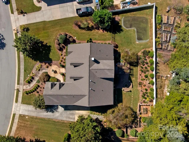 an aerial view of a house with a swimming pool