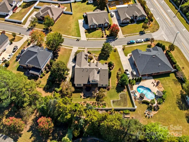 an aerial view of a house with a yard basket ball court and outdoor seating