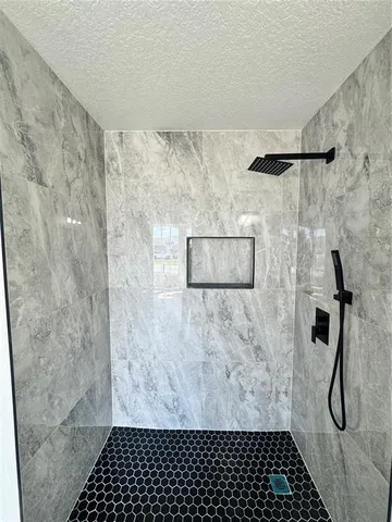 an empty room with wooden floor and closet area