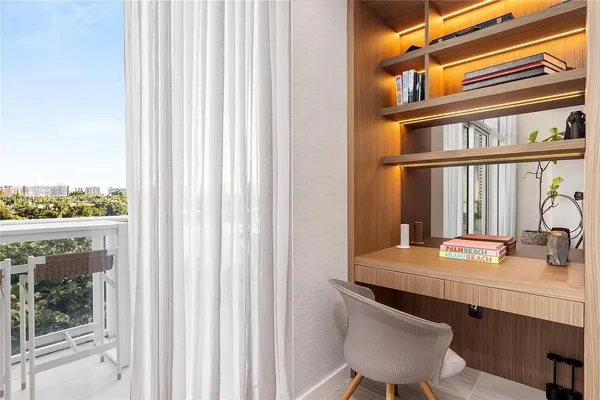 a living room with furniture a floor to ceiling window and flat screen tv