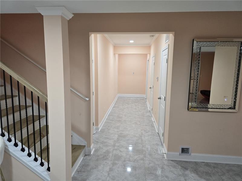 6850 Rocking Horse Lane Cumming, GA 30040 - Photo 24 of 36 a view of a hallway with wooden floor and staircase