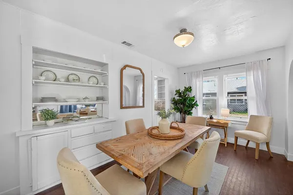 a view of a dining room with furniture and a window
