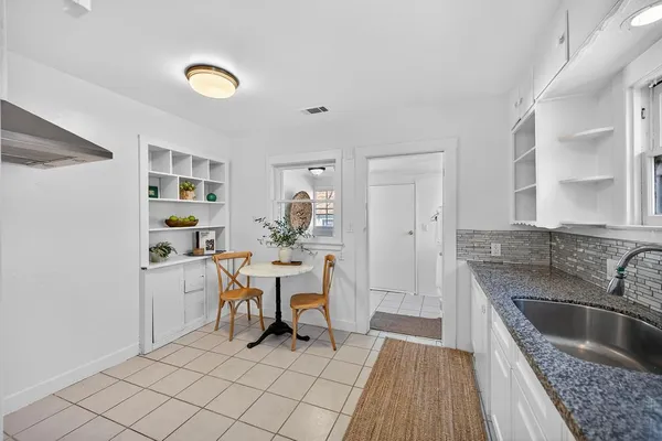 a kitchen with stainless steel appliances granite countertop a sink dishwasher and cabinets with wooden floor