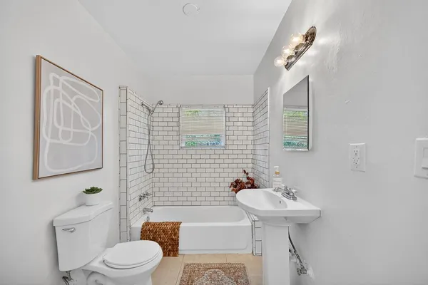 a bathroom with a sink a toilet and mirror