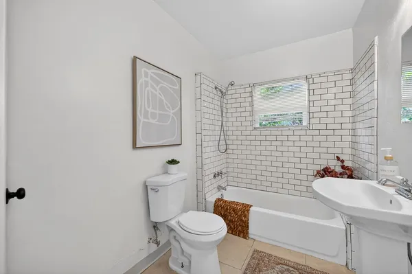 a white toilet sitting next to a bathroom sink