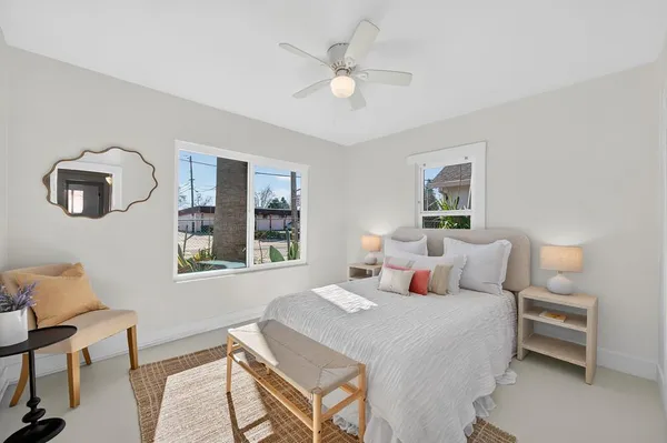 a bedroom with a bed a table and chair