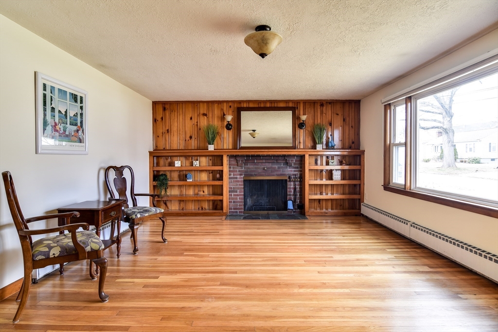 8 Edwards Road Natick, MA 01760 - Photo 11 of 29 a living room with furniture a fireplace and a large window