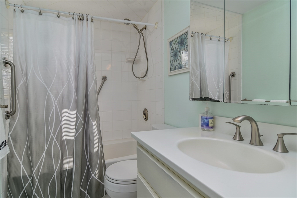 8 Edwards Road Natick, MA 01760 - Photo 14 of 29 a bathroom with a sink a toilet and shower