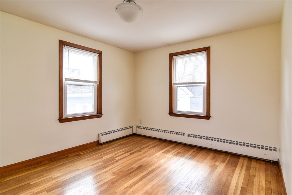 8 Edwards Road Natick, MA 01760 - Photo 15 of 29 a view of an empty room with wooden floor and a window