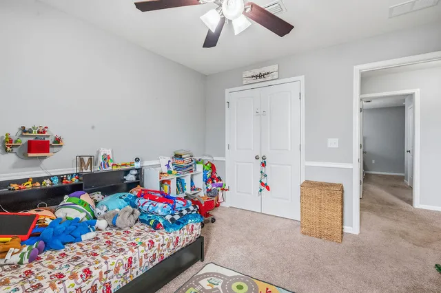 a bedroom with a large bed and a window