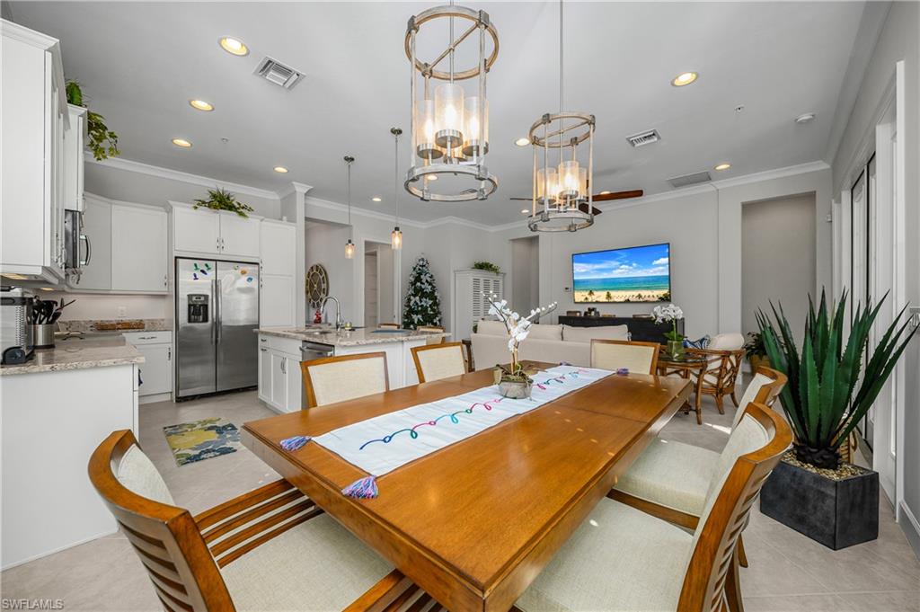 6552 Dominica Drive, Unit 101 Naples, FL 34113 - Photo 10 of 50 a room with gym equipment and a chandelier