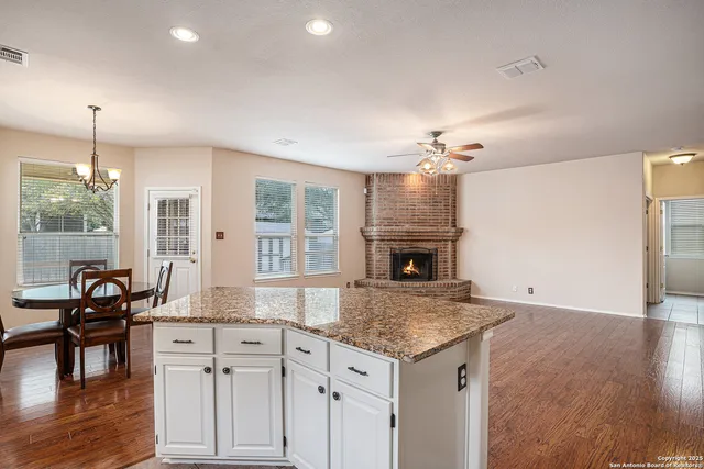 a kitchen with granite countertop a stove and a sink
