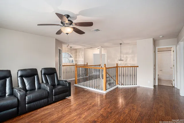 a view of a livingroom with furniture and hardwood floor