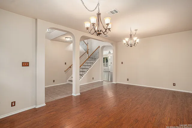 wooden floor in an empty room with a mirror