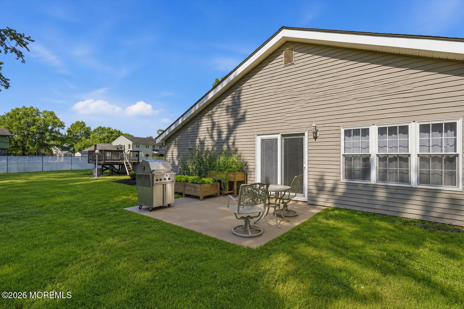 22 Ethan Allen Road Freehold, NJ 07728 - Photo 15 of 31 a backyard of a house with table and chairs