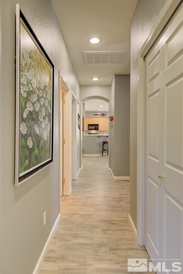 10482 Gold Trail Drive Reno, NV 89521 - Photo 12 of 40 a view of a hallway with wooden floor and a living room