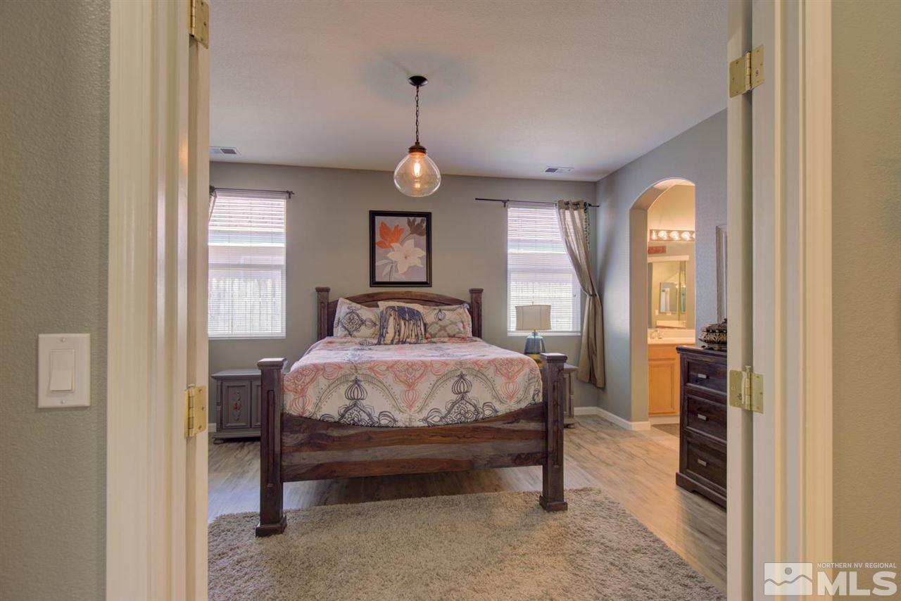 10482 Gold Trail Drive Reno, NV 89521 - Photo 13 of 40 a bedroom with a bed and a mirror