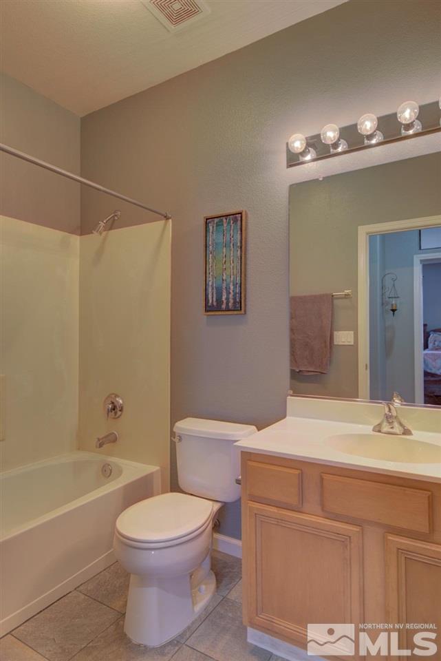 10482 Gold Trail Drive Reno, NV 89521 - Photo 23 of 40 a bathroom with a sink a toilet and shower