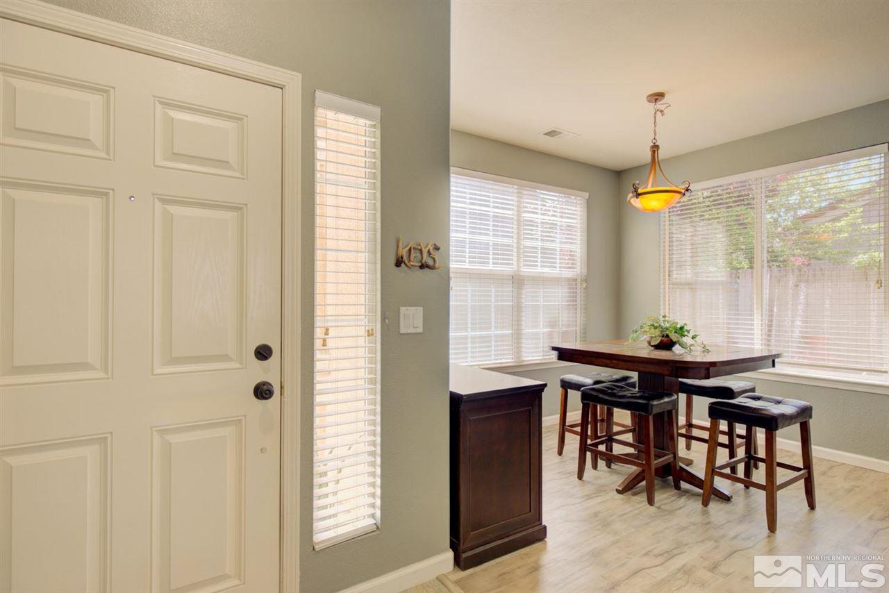 10482 Gold Trail Drive Reno, NV 89521 - Photo 3 of 40 a view of a dining room with furniture window and wooden floor