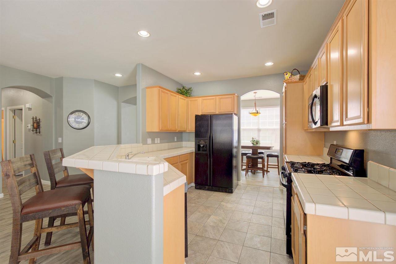 10482 Gold Trail Drive Reno, NV 89521 - Photo 9 of 40 a kitchen with a refrigerator a sink and a stove