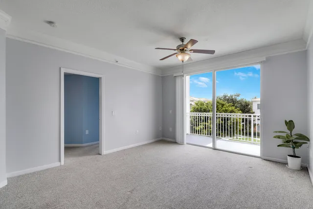 a view of a kitchen and a chandelier fan