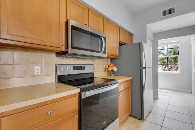 a kitchen with a sink appliances and cabinets