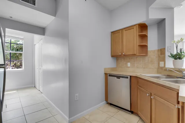 a kitchen with a refrigerator a stove and a sink