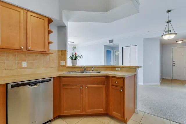 a view of a kitchen with a sink and a window
