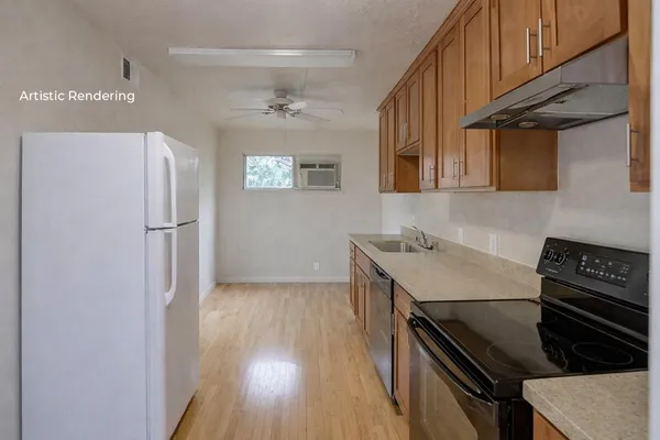 a kitchen with a refrigerator and a stove top oven