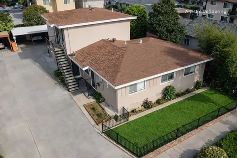 an aerial view of a house with a yard
