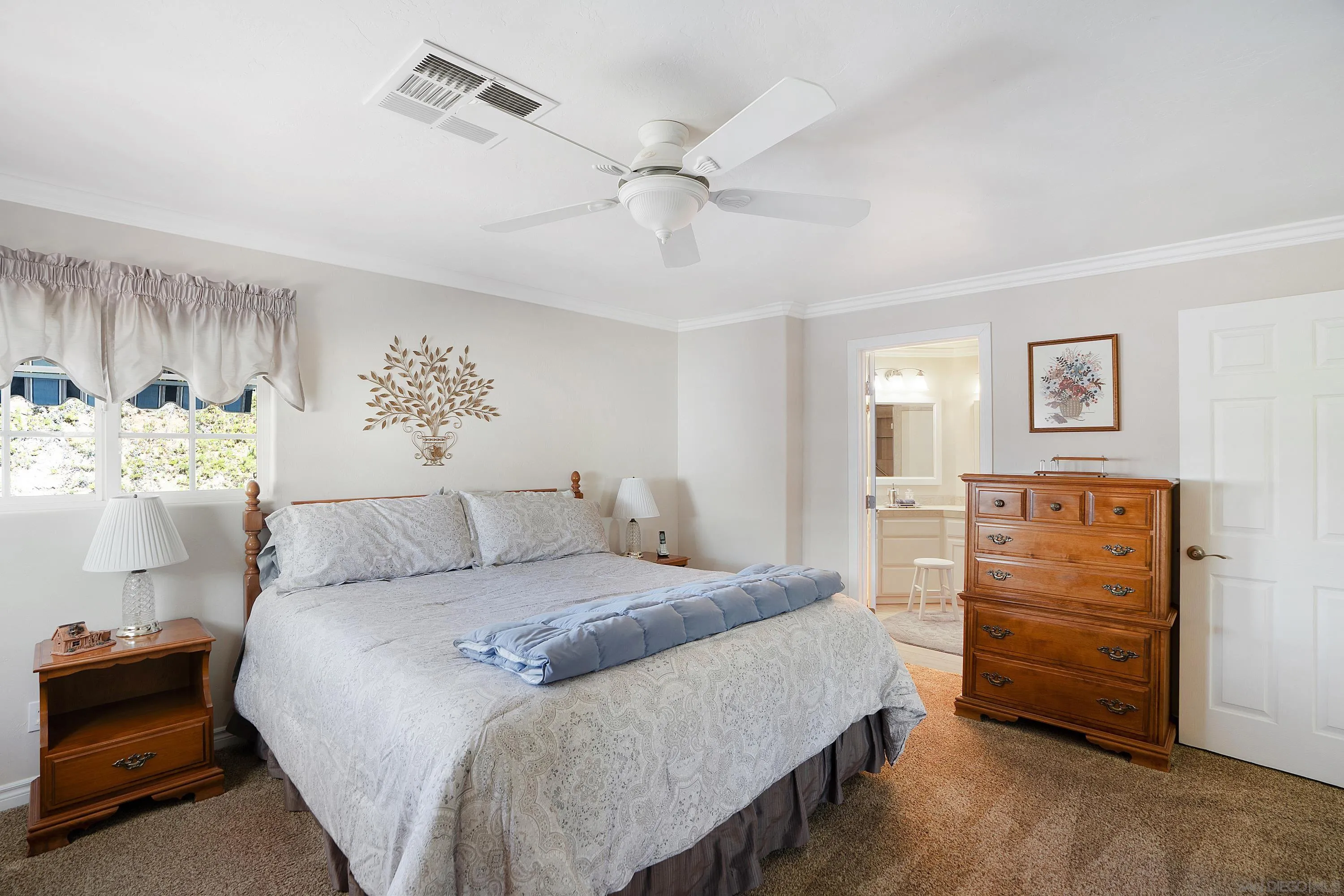 9500 Harritt Road, Unit 234 Lakeside, CA 92040 - Photo 17 of 29 a bedroom with a bed and a chandelier