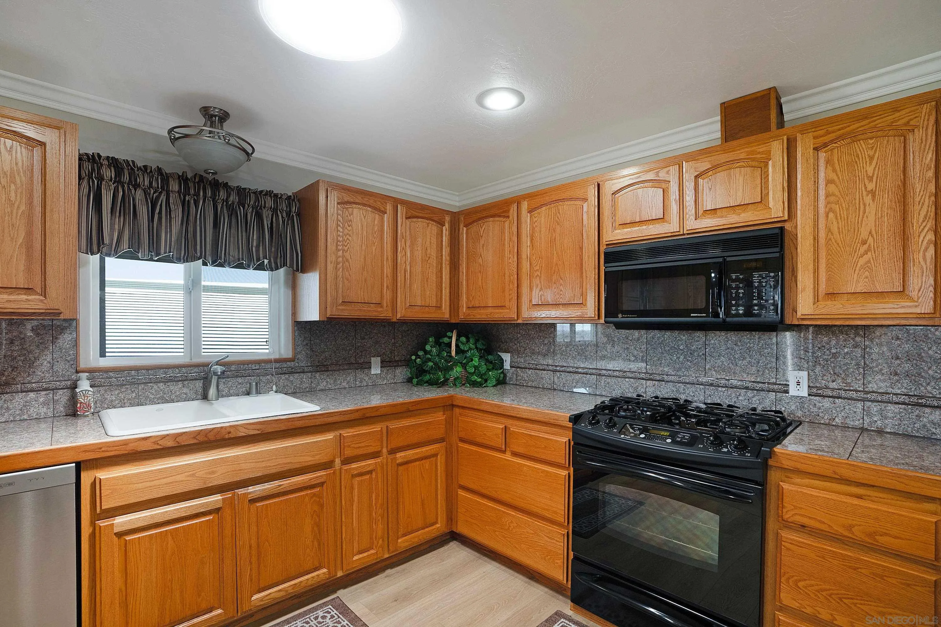9500 Harritt Road, Unit 234 Lakeside, CA 92040 - Photo 8 of 29 a kitchen with granite countertop a sink stainless steel appliances and cabinets
