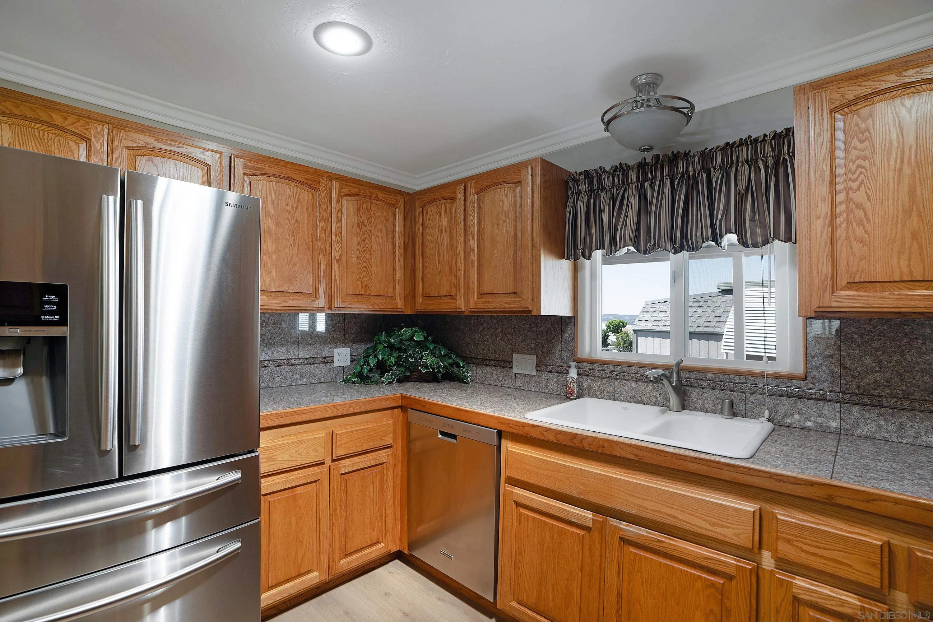 9500 Harritt Road, Unit 234 Lakeside, CA 92040 - Photo 9 of 29 a kitchen with granite countertop a refrigerator and a sink