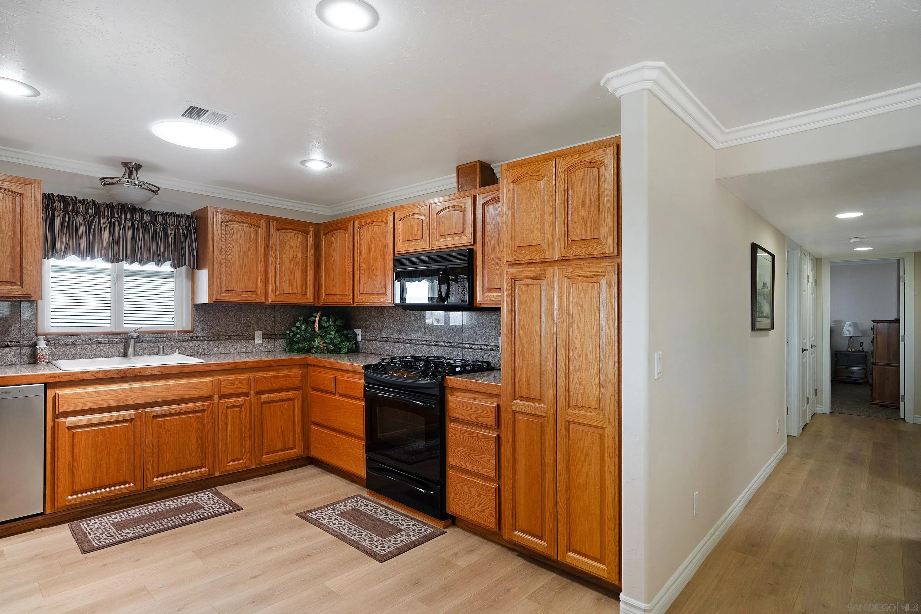 9500 Harritt Road, Unit 234 Lakeside, CA 92040 - Photo 10 of 29 a kitchen with stainless steel appliances granite countertop a refrigerator stove top oven and sink